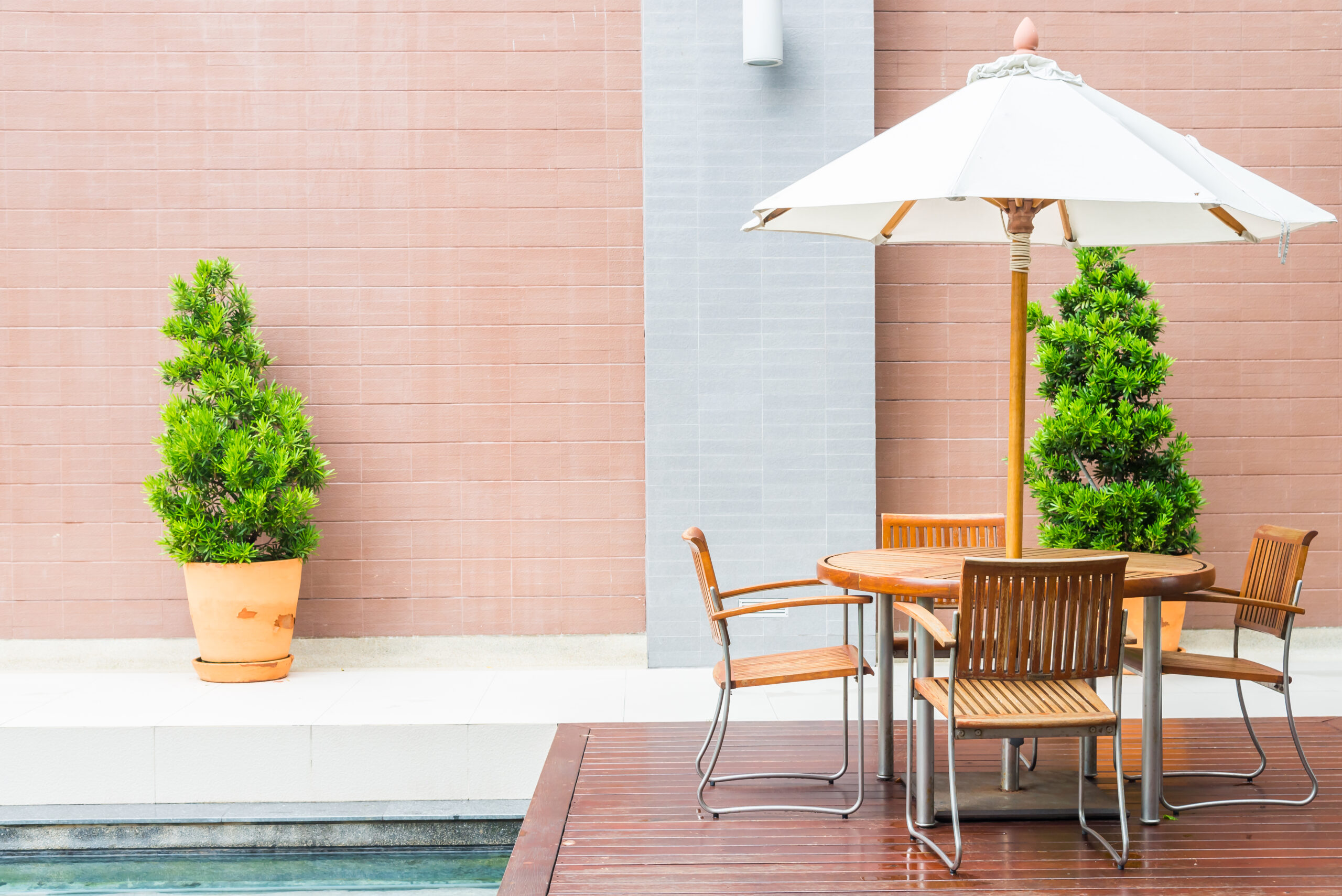Table and chair with white umbrella outdoor patio